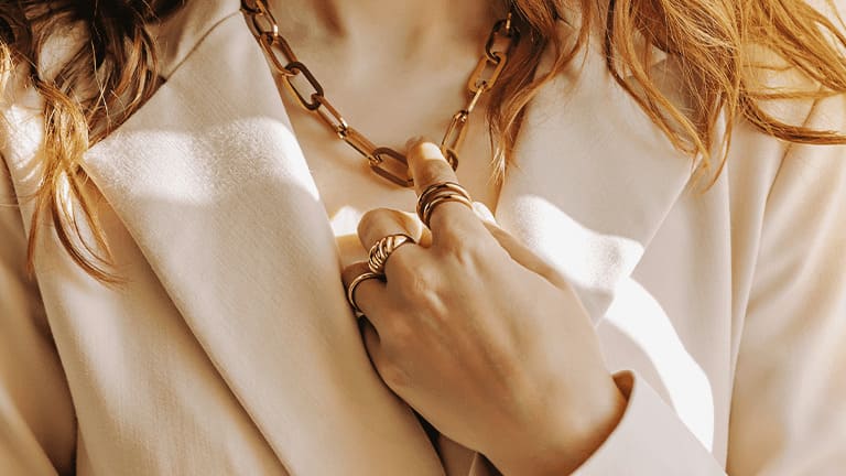 woman holding her necklace